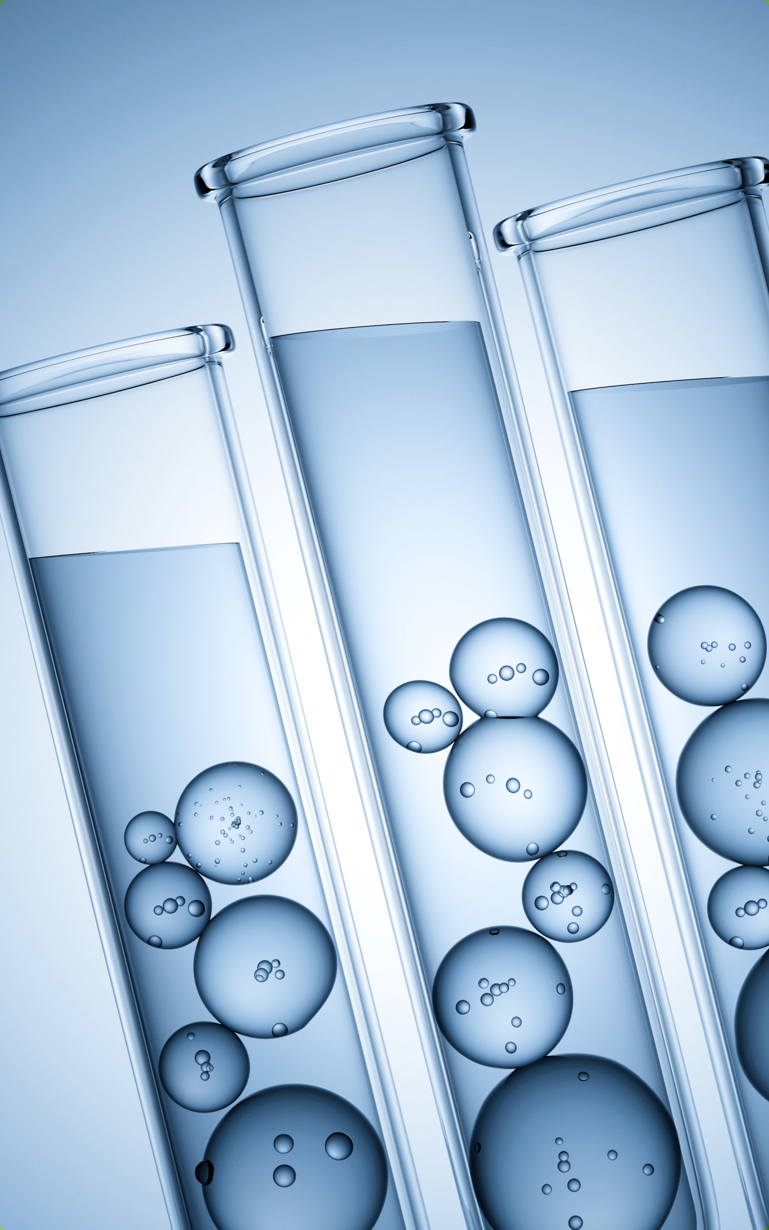 Three test tubes with water and bubbles on a blue background