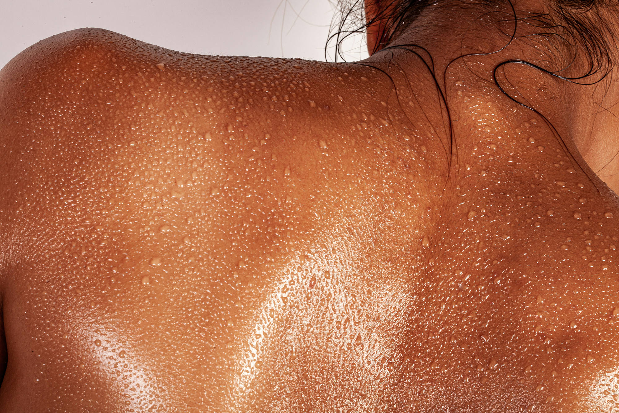 Shiny, sun-kissed back with a light background